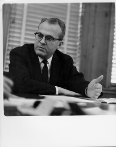 John W. Lederle seated indoors