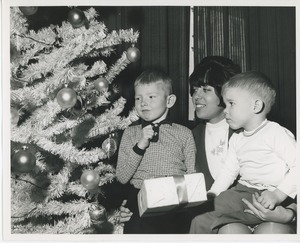 Susan Heller with two young boys under Christmas tree