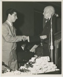 Unidentified staff shaking hands with client at Institute Day