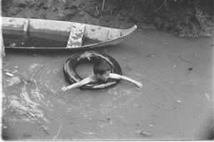 Child swimming in canal; Luong Hoa Village.