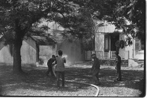 Burning of the U.S. consulate in Hue. Firemen trying to put down the flames; Hue.