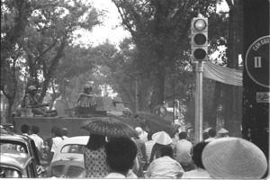 U.S. tanks moving through Saigon traffic; Saigon.