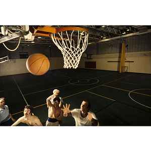 Group of players trying to catch a basketball