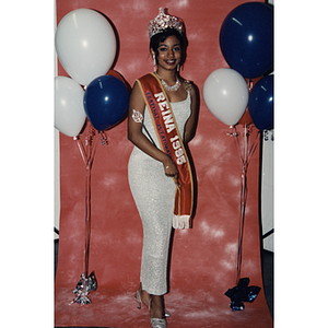 A woman with a large crown and a sash at the Festival Puertorriqueño