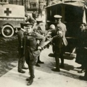 Photograph of bearers removing patient from ambulance at American Ambulance Hospital, circa 1915.