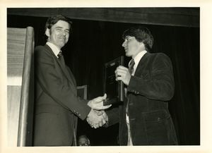 Athletics Director James E. Nelson presents award to student Jon Caron at Suffolk University's 1978 Recognition Day ceremony
