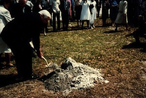 Thomas P. O'Neill lifting shovelfull of dirt, crowd in background