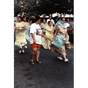 Women in folk dance costumes walk in the 1998 Festival Betances parade.