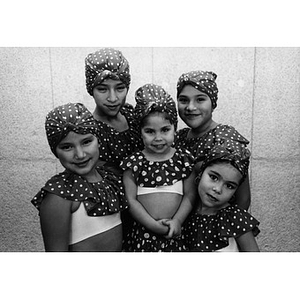 Five girls pose for a portrait wearing their folk dance costumes.