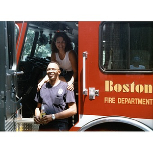 Woman sitting in the driver's seat of a Boston Fire Department truck that is parked at the 1999 Festival Betances.