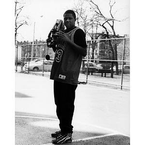 Portrait of a young man with a video camera.