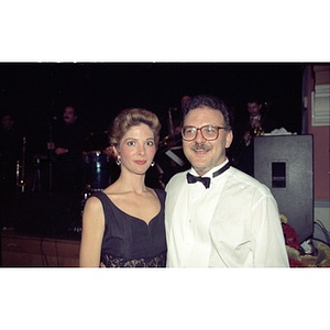 Couple in formal wear pose for the camera.