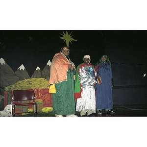 Three men dressed as the Three Kings stand on the stage of the Jorge Hernandez Cultural Center during a Three Kings Day celebration.