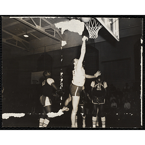 A basketball player throwing a ball towards the hoop during the Boys' Clubs of Boston 41st Basketball Tournament