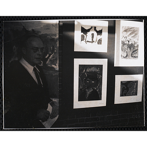 Dwight C. Shepler, Overseer of the Boys' Clubs of Boston, views the Boys' Clubs of Boston Tri-Club Art Exhibit at the Museum of Science