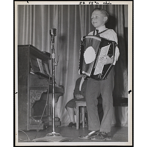 A Boys' Clubs of Boston member playing accordion on the stage