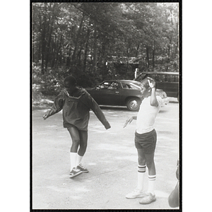 Two children dancing in a circle outside