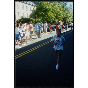 A boy runs during the Battle of Bunker Hill Road Race