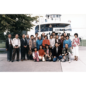 Chinese Progressive Association members pose in front of a ship of the Toronto Island Ferry Service