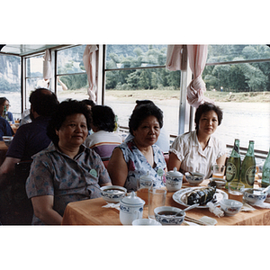 Women partiicipate in a boat cruise through Guilin during a CPA trip to China
