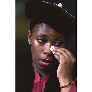 Commencement speaker Donna Harris-Lewis wiping away tears