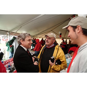 President Freeland speaks with a Northeastern supporters before the Homecoming game