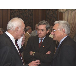 Three men talking at gala dinner for John Hatsopoulos, on right