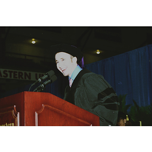 Unidentified man speaking at podium during the School of Law commencement