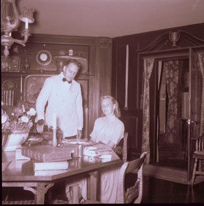 Woman seated at table, being served by butler, Beauport, Sleeper-McCann House, Gloucester, Mass.