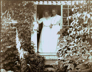 Full-length informal portrait of Emily Davis Tyson and Sarah Orne Jewett standing in the doorway of Hamilton House, South Berwick, Maine, undated