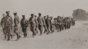 Street-level view of German prisoners walking along a road