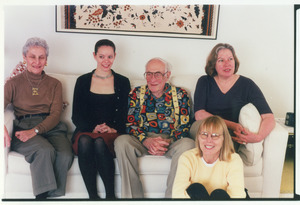 Sidney Lipshires with family and friends, seated on a couch