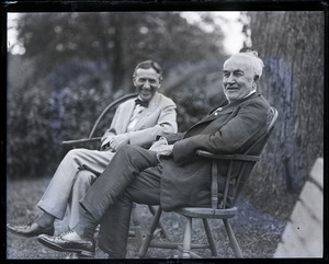 Group sitting on Windsor chairs on the lawn at the Fireside Inn: Harvey Firestone and Thomas A. Edison (l. to r.)