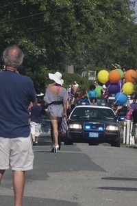 Police escort leading the approaching parade : Provincetown Carnival parade