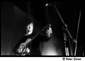 The Byrds and Flying Burrito Brothers performing at the Boston Tea Party: Roger McGuinn playing guitar (partial double exposure)