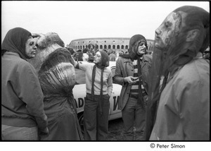 Anti-war rally at Soldier's Field, Harvard University: demonstrators wearing masks by a large mourning puppet