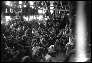 Michael Metelica addressing a crowd of commune members at a meeting inside the Brotherhood of the Spirit dormitory, Warwick, Mass. (damaged image)