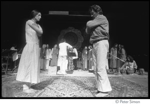 Man and woman bowing to each other on stage at the Kohoutek Festival of Consciousness