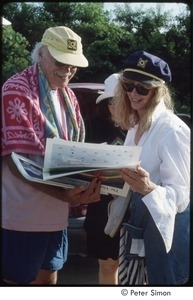Ram Dass and Susan Harris looking at Peter Simon's Vineyard calendar, Sharon Salzberg in the background