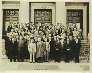 Faculty members posing on stairs to entrance of Stockbridge Hall