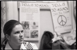 Young Americans for Freedom (YAF) office: YAF member seated in front of posters for "Tell it to Hanoi" rally