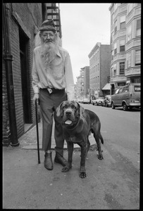 Prescott Townsend standing with a large dog on a Beacon Hill street