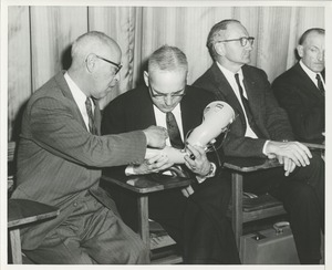 Cal Fletcher, Eugene Murphy, and Dr. Bechtol looking at a prosthetic