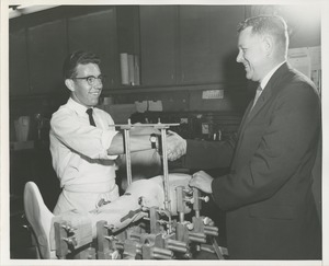 Willis C. Gorthy shakes hands with a technician in the Prosthetics and Orthotics lab