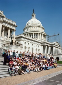 Congressman John W. Olver with group of visitors, posed on the steps of the United States Capitol building