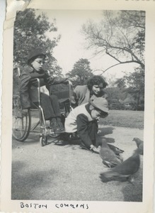 Bernice Kahn feeding pigeons with sons Joel and Paul in Boston Commons