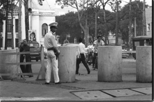 Saigon police guarding U.S. building against Vietcong terrorists.