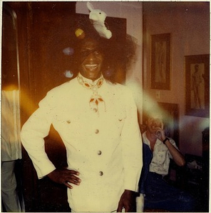 A Photograph of Marsha P. Johnson Wearing a White Outfit and an Easter-themed Headpiece