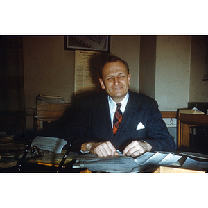 W. White seated at desk