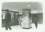 Students in front of the bulletin board in the lobby of Suffolk University's Sawyer Building (8 Ashburton Place), photograph, 1982